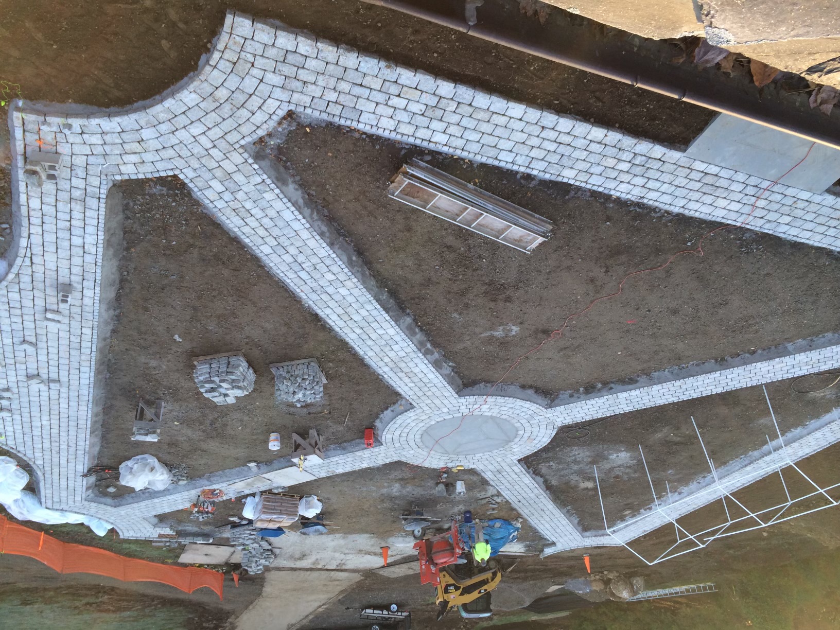 Large cobblestone courtyard with circular center medallion