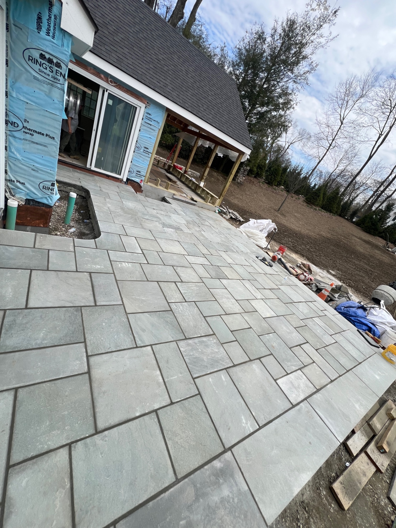 Large bluestone patio installed behind a home