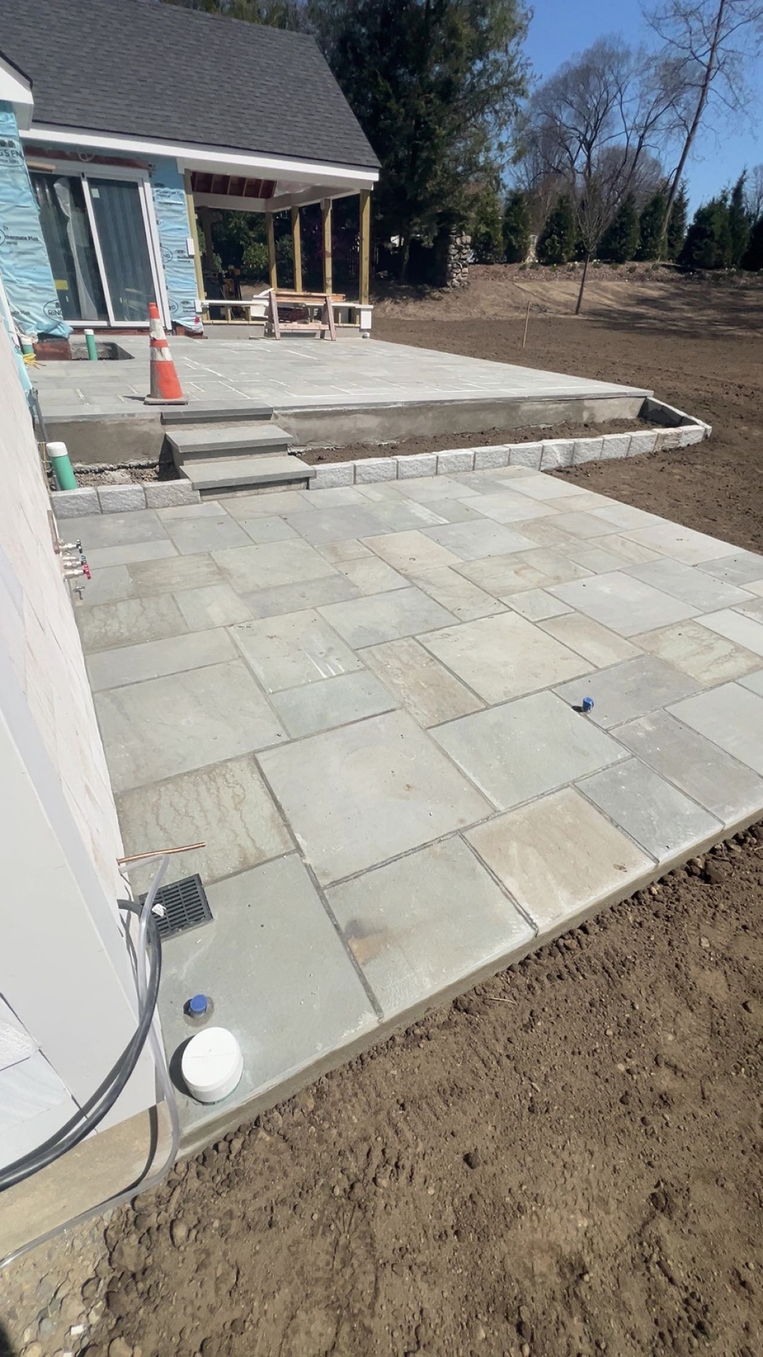 Tiered patio connected by bluestone steps