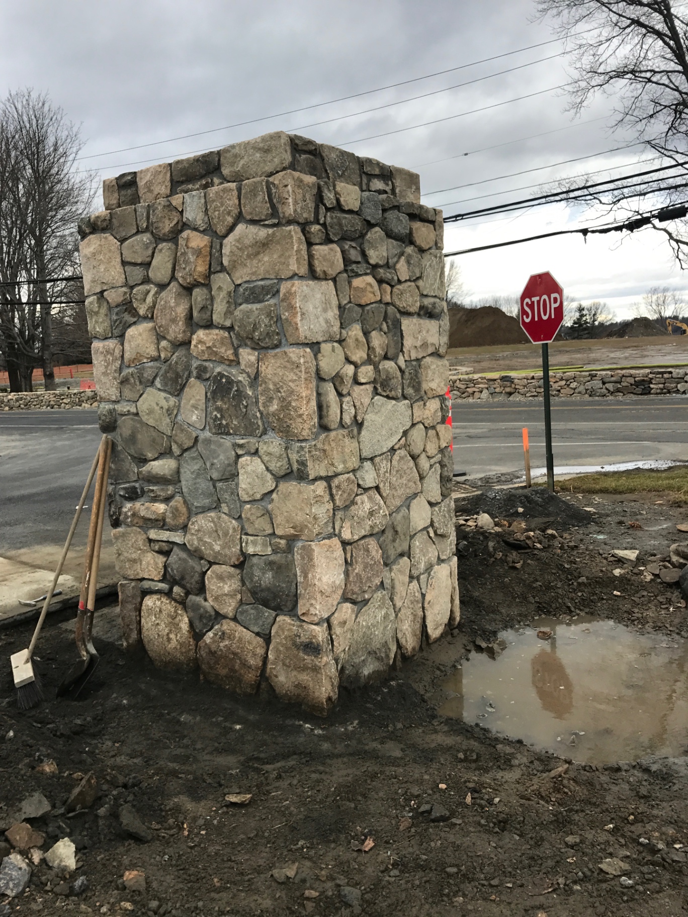 Fieldstone entrance pillar at a roadway corner